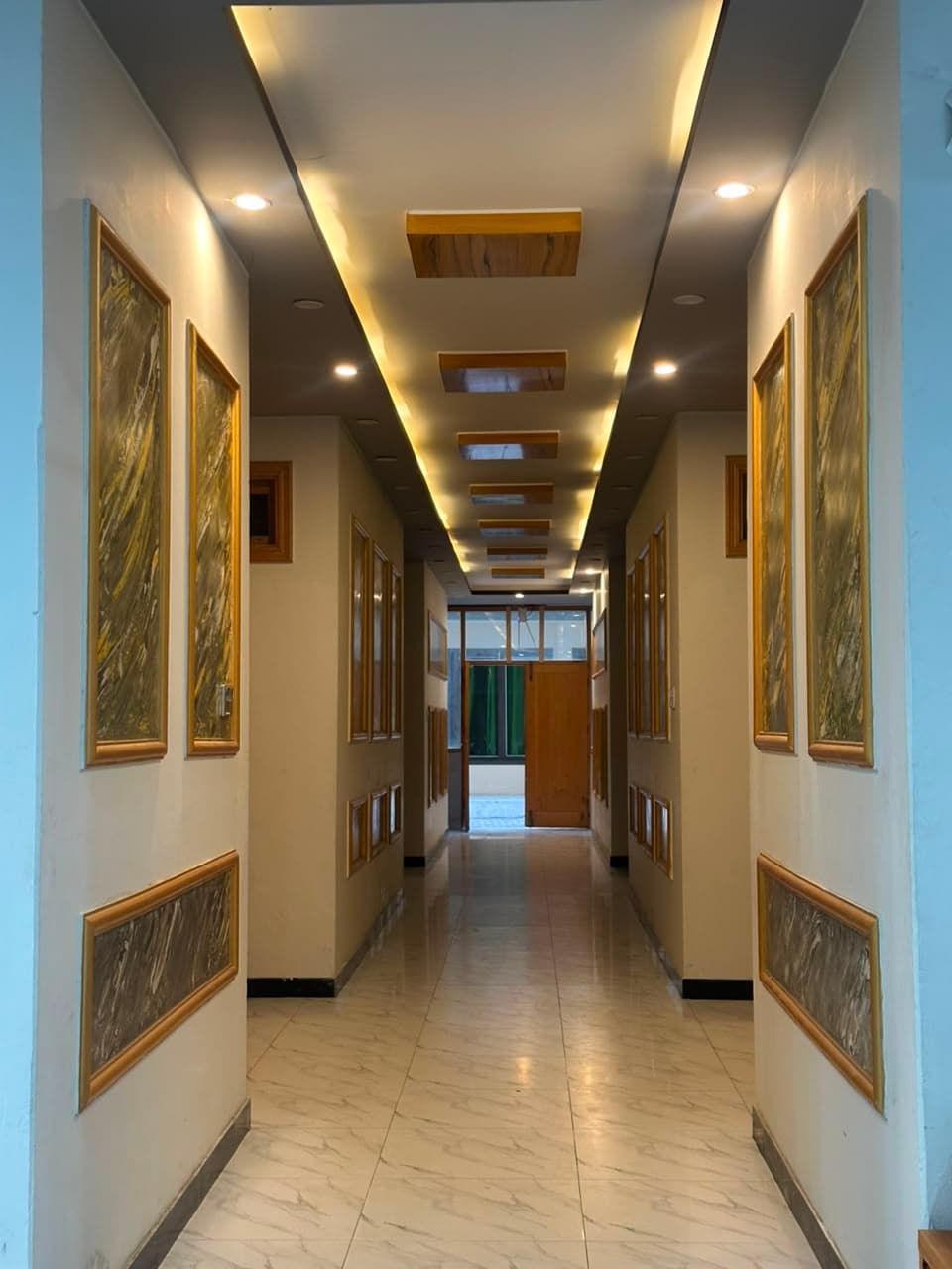 Comfort Inn Kalam hallway with framed artwork and elegant lighting